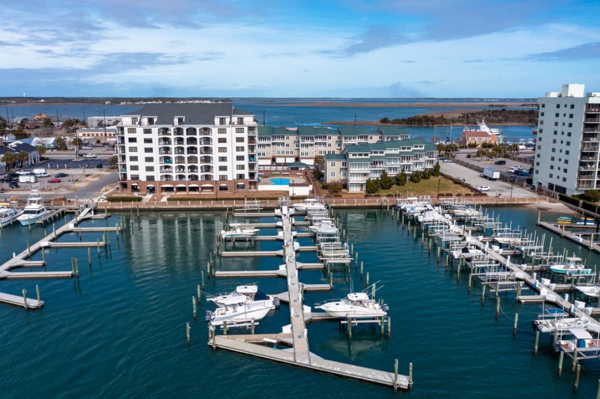 Aerial,view,of,condos,and,a,marina,with,boats,in